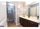 Bathroom featuring a dark wood vanity, shower and decorative prints on the walls at 5143 Olive Branch Cir, Powder Springs, GA 30127