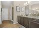Bathroom featuring granite countertop, a walk-in shower with glass door, and neutral tile flooring at 5143 Olive Branch Cir, Powder Springs, GA 30127