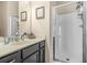 Bathroom with vanity, granite countertop, single sink and a framed shower stall with a clear glass door at 5143 Olive Branch Cir, Powder Springs, GA 30127