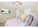 Bright bedroom featuring a ceiling fan, wall-mounted TV, and stylish decor at 5143 Olive Branch Cir, Powder Springs, GA 30127