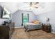 Neutral bedroom with wall-mounted TV and a window with sheer curtains at 5143 Olive Branch Cir, Powder Springs, GA 30127
