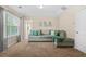 Cozy bedroom with neutral tones, a comfortable seating area, and ample natural light at 5143 Olive Branch Cir, Powder Springs, GA 30127