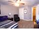 Bedroom with carpet, a ceiling fan, a reading chair and decor at 5143 Olive Branch Cir, Powder Springs, GA 30127