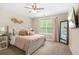 Cozy bedroom with neutral walls, ceiling fan, and comfy bed with decorative pillows at 5143 Olive Branch Cir, Powder Springs, GA 30127