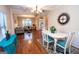 Open-concept dining area with hardwood floors, stylish furniture, and seamless transition to living space at 5143 Olive Branch Cir, Powder Springs, GA 30127