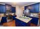 Modern kitchen with stainless steel appliances, granite countertops, and ample cabinet space with an island at 5143 Olive Branch Cir, Powder Springs, GA 30127