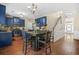 Eat-in kitchen with stainless steel appliances, dark blue cabinets and hardwood floors at 5143 Olive Branch Cir, Powder Springs, GA 30127