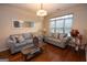 Cozy living room with hardwood floors, stylish sofas, and large windows offering natural light at 5143 Olive Branch Cir, Powder Springs, GA 30127