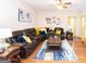 Spacious living room with hardwood floors, stylish decor, and comfortable seating, ideal for relaxation at 5143 Olive Branch Cir, Powder Springs, GA 30127