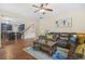 Open-concept living room with hardwood floors, a leather sofa and view of the kitchen at 5143 Olive Branch Cir, Powder Springs, GA 30127