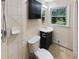 Updated bathroom features a tiled wall, modern vanity, and a dark cabinet at 724 Dukehart Ct, Stone Mountain, GA 30083