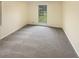 Neutral bedroom features a large window, carpet, and ample natural light at 724 Dukehart Ct, Stone Mountain, GA 30083