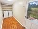 Bright laundry room featuring a washer, dryer, shelving, and hardwood floors at 724 Dukehart Ct, Stone Mountain, GA 30083