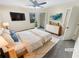 Virtually staged bedroom featuring a large window, closet, and a modern dresser at 724 Dukehart Ct, Stone Mountain, GA 30083