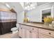 Bathroom boasts a large vanity, granite countertop, stylish mirror, and a shower with curtain at 90 W Peachtree St, Norcross, GA 30071