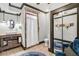 Charming bathroom features a rustic vanity, tiled shower, and stylish blue rug at 90 W Peachtree St, Norcross, GA 30071