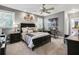 Spacious bedroom featuring a ceiling fan, carpet floors, neutral walls and a bed with pillows at 90 W Peachtree St, Norcross, GA 30071