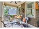 Inviting covered porch with comfortable seating and a view of the lush surroundings at 90 W Peachtree St, Norcross, GA 30071