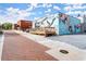 Charming brick building featuring a mural and outdoor seating on a beautiful brick street at 90 W Peachtree St, Norcross, GA 30071