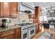 Well-equipped kitchen with stainless steel range, custom cabinetry, and seamless transition to other living areas at 90 W Peachtree St, Norcross, GA 30071