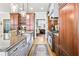 Open-concept kitchen with granite island, stainless appliances, and seamless access to other living spaces at 90 W Peachtree St, Norcross, GA 30071
