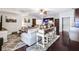 Open living room with a sofa and island seating and wood floors at 90 W Peachtree St, Norcross, GA 30071