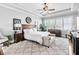 Serene main bedroom suite featuring tray ceilings, a seating area, and large windows at 90 W Peachtree St, Norcross, GA 30071