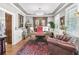 Luxurious office with a decorative chandelier, hardwood floors, and an antique desk at 90 W Peachtree St, Norcross, GA 30071