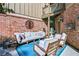 Cozy outdoor seating area with comfortable furniture and a decorative brick wall at 90 W Peachtree St, Norcross, GA 30071