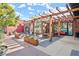 Outdoor patio with pergola, multiple tables and chairs, and brick facade is perfect for dining al fresco at 90 W Peachtree St, Norcross, GA 30071