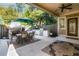 Spacious patio features a cozy fireplace, outdoor kitchen, and stylish dining set at 90 W Peachtree St, Norcross, GA 30071