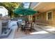 Charming outdoor space with a cozy fireplace, grill, and dining area at 90 W Peachtree St, Norcross, GA 30071
