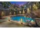Beautiful backyard pool featuring lovely lighting and landscaping that creates a relaxing outdoor oasis at 90 W Peachtree St, Norcross, GA 30071
