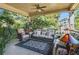 Inviting covered porch with comfortable seating, stylish rug, and lush greenery views at 90 W Peachtree St, Norcross, GA 30071