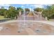 Interactive splash pad with fountains in Lillian Webb Park with landscaped surroundings at 90 W Peachtree St, Norcross, GA 30071