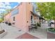 Corner building with antique store signage, sidewalk seating, and lush potted plants, creating a charming atmosphere at 90 W Peachtree St, Norcross, GA 30071