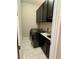 Well organized laundry room showcasing modern black cabinetry, washer, and dryer at 1194 John Collier Rd, Atlanta, GA 30318