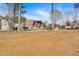 Large grassy backyard between neighboring homes with a gorgeous red tree at 2445 Ridgelake Dr, Villa Rica, GA 30180