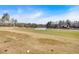 The backyard overlooks a green golf course with a pond, offering a peaceful view at 2445 Ridgelake Dr, Villa Rica, GA 30180