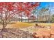 Open backyard with lake view, wood deck, patio, and firepit at 2445 Ridgelake Dr, Villa Rica, GA 30180