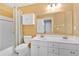 Bright bathroom featuring double sink vanity, toilet, and shower-tub combination at 2445 Ridgelake Dr, Villa Rica, GA 30180