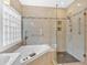 Luxurious bathroom with walk-in glass shower, soaking tub, and modern fixtures at 2445 Ridgelake Dr, Villa Rica, GA 30180