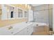 Well-lit bathroom featuring double vanity, tile floors, and walk-in shower at 2445 Ridgelake Dr, Villa Rica, GA 30180