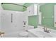 Clean bathroom features a tub with white tiling and a neutral-colored vanity with countertop sink at 2445 Ridgelake Dr, Villa Rica, GA 30180