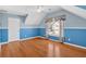 Bright bedroom boasts blue and white accents, paired with hardwood floors and natural light at 2445 Ridgelake Dr, Villa Rica, GA 30180