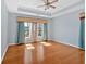 Spacious bedroom with a tray ceiling, hardwood floors, and natural light at 2445 Ridgelake Dr, Villa Rica, GA 30180