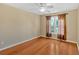 Relaxing bedroom with a ceiling fan, hardwood floors, and a window covered with brown curtains at 2445 Ridgelake Dr, Villa Rica, GA 30180