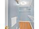 Spacious walk-in closet with built-in white shelving and wood flooring at 2445 Ridgelake Dr, Villa Rica, GA 30180