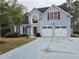 Classic home exterior with a well-kept lawn, trimmed bushes, and a two-car garage, presenting a tidy and inviting facade at 2445 Ridgelake Dr, Villa Rica, GA 30180