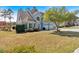 Beautiful home exterior with a manicured lawn, mature trees, and a two-car garage, exuding suburban charm at 2445 Ridgelake Dr, Villa Rica, GA 30180